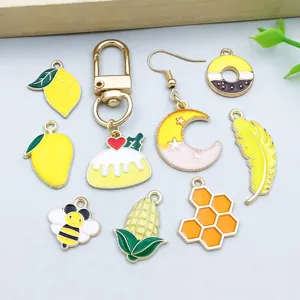 Variety of yellow enamel alloy charms featuring bees, lemons, and moon for DIY jewelry.