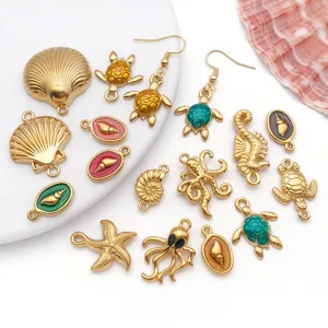 Macro detail of ocean-themed stainless steel enamel charms with high-quality gold plating
