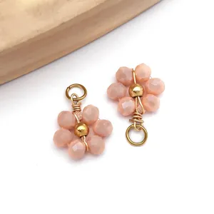 Detailed macro view of a pink beaded daisy flower charm pendant for custom DIY jewelry making.