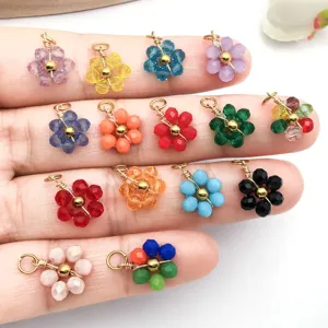 Close-up detail of various colorful crystal bead daisy flower pendants for handmade DIY jewelry