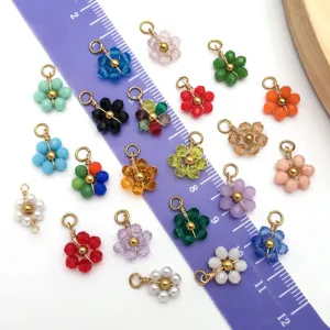 Variety of colorful flower-shaped bead charms for DIY jewelry making shown with ruler