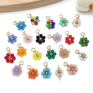 Macro view of colorful bead flower pendants in various shades on white background