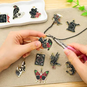 Detailed view of DIY Halloween charms being assembled with pliers for handmade jewelry