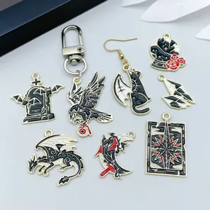 Detailed view of assorted black enamel Halloween charms featuring dragons, ravens and cats.