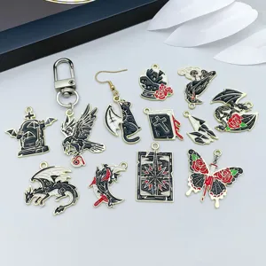 Macro detail showing gothic Halloween enamel charms including dragons and crows