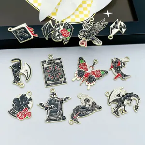 Detailed view of assorted black enamel Gothic Halloween charms with gold finish