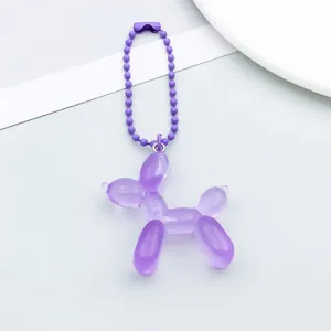 Detail of a purple translucent balloon dog pendant with matching purple ball chain