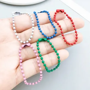 Close-up of colorful alloy bead chains in various finishes for DIY jewelry making.
