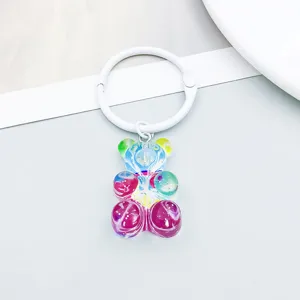 Close-up of a colorful resin bear pendant with a white binder ring for DIY crafts