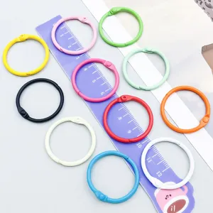 Close-up of colorful painted metal loose-leaf binder rings in various vibrant colors