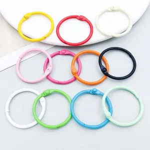 Close-up of colorful painted metal binder rings in various vibrant shades for DIY handmade crafts