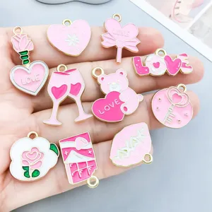 Detail view of various pink enamel Valentine's Day alloy charms with heart and rose designs