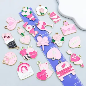 Detailed view of pink enamel Valentine charms with ruler scale showing size and texture