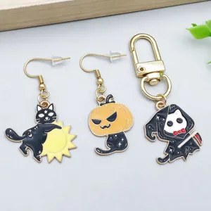 Macro view of Halloween cat charms including pumpkin and ghost designs
