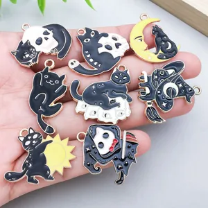 Detail view of black and white enamel cat charms with Halloween skull and moon motifs