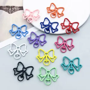 Detailed macro view of colorful bow-shaped metal lobster clasps for DIY jewelry making