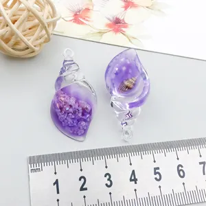 Detailed view of purple resin seashell pendants for DIY jewelry with size ruler