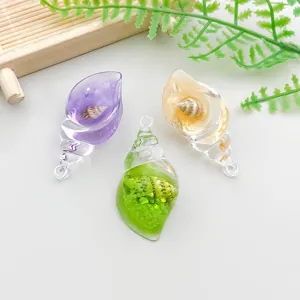 Macro shot of colorful transparent resin conch pendants with inner shell details
