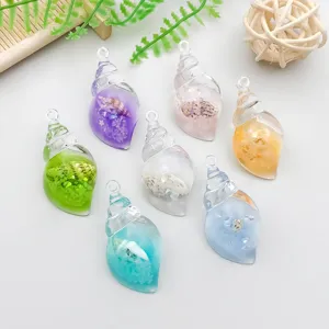 Close-up of seven colorful transparent resin sea snail shell charms for DIY jewelry