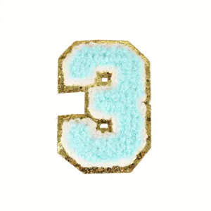 Detail shot of blue chenille number 3 patch with gold glitter border for apparel DIY decor.