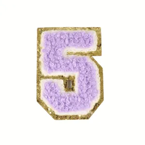 Close-up detail of purple chenille number 5 patch with sparkly gold glitter border.