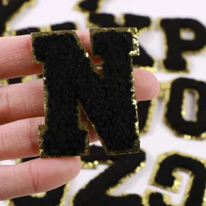 Black chenille letter patch with gold glitter border for DIY clothing and bags detail shot.