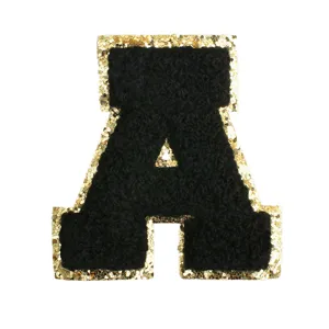 Detail shot of black chenille letter A patch featuring sparkling gold sequin border design.
