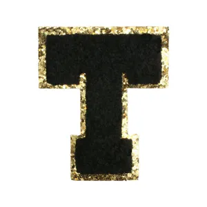 Black chenille letter T embroidered patch with gold glitter border for DIY clothing and bags.