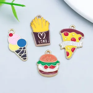 Close-up of colorful cartoon food charms like ice cream and pizza for DIY jewelry.