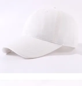 Close-up detail of the white cotton baseball cap showing fine stitching and soft crown design.