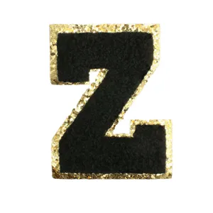 Close-up detail of black chenille letter Z patch featuring a sparkling gold glitter border.