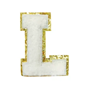 White chenille letter L patch with shiny gold glitter border, DIY accessory detail.