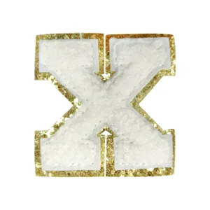 White towel embroidery gold glitter letter X patch, clothing DIY accessory detail view.