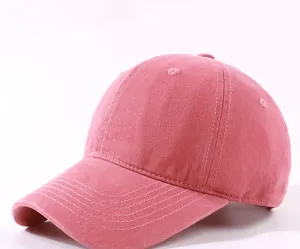 Pink washed cotton baseball cap detail showcasing soft crown and curved brim stitching.