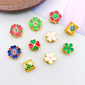 Close-up of colorful enamel flower and clover alloy spacer beads for jewelry DIY
