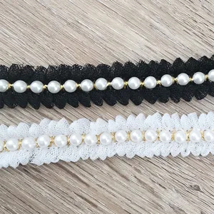 Detailed close-up of black and white lace pearl trim ribbon for DIY sewing and gift wrapping.