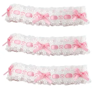 Dettaglio in primo piano di passamaneria in pizzo bianco con fiocchi rosa per cucito fai