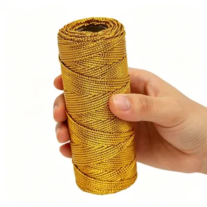 Close-up detail shot of the gold metallic thread roll being held to show its braided texture.