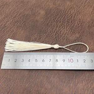 Close-up detail of 8cm DIY beige tassel with hanging loop, shown with a ruler for size.