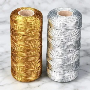 Close-up detail of metallic gold and silver craft cords, perfect for gift wrapping and decor.
