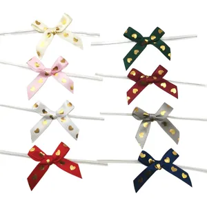 Gold foil heart ribbon bows with twist ties for gift box decoration and DIY crafts.