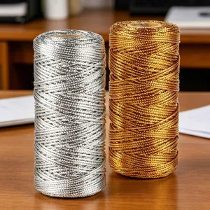Detailed view of gold and silver metallic cord spools, 1mm braided thread for crafts.