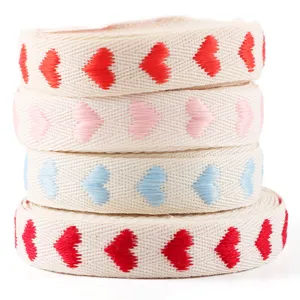 Detail shot of 1.6cm heart jacquard ribbon roll, perfect for gift wrapping and wedding decor.