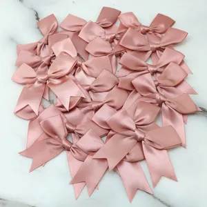Pink satin ribbon bows set for DIY craft gift box decoration and handmade hair accessories.