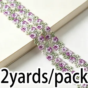 Detailed shot of colorful hollow water-soluble lace embroidery trim for DIY sewing crafts.