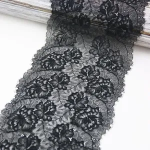 Close up of black stretch floral lace trim detail, beautiful lace fabric texture for sewing.