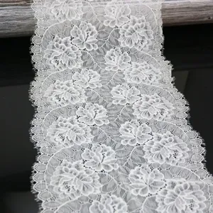 White elastic lace trim detail, 23cm wide floral fabric for sewing apparel and DIY craft projects.