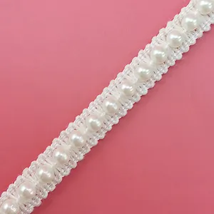 Close-up detail of white pearl lace trim ribbon, perfect for DIY crafts and accessories.