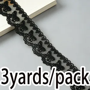Detail view of 4cm black bow embroidered mesh lace trim, ideal for DIY sewing and apparel crafts.
