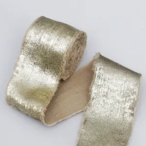 Gold velvet ribbon trim detail shot, plush metallic fabric tape for sewing, gift wrapping crafts.